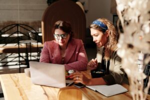 pic of two women working together on a laptop